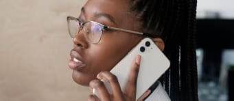 Woman wearing glasses and talking on a cell phone